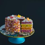 sliced cake top with star raisins on cake stand